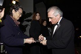 Martin Scorsese delights a fan with an autograph.