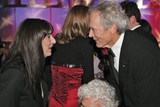 Presenter Anjelica Huston congratulates Clint Eastwood.