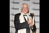 Director Bertrand Tavernier holds up his cystal eagle for the press cameras. (Photo by Peter Kramer/Getty Images)