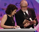 Liz Ryan accepts the 2008 Capra Achievement Award from DGA Secretary-Treasurer Gil Cates.